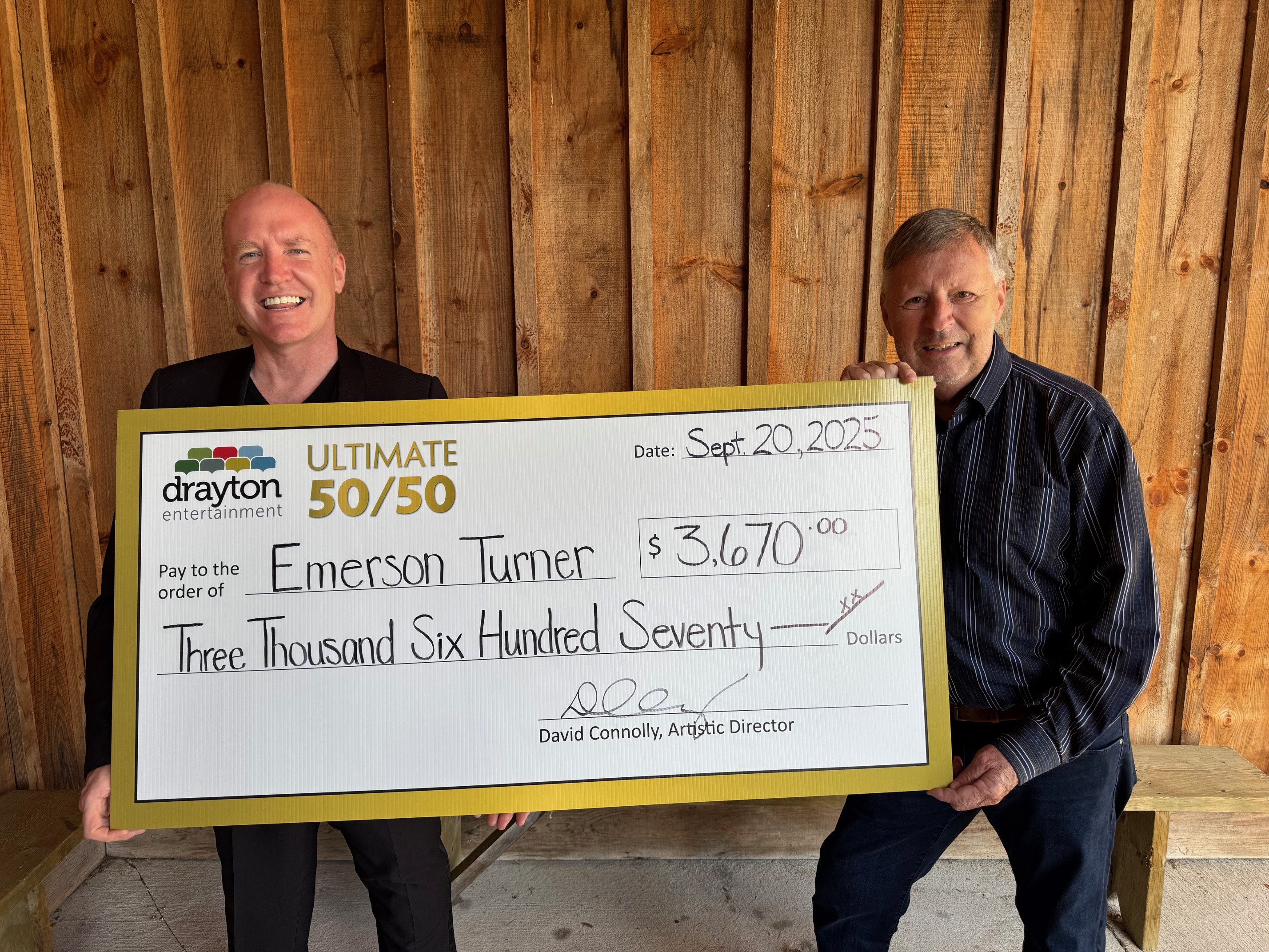 David Connolly presents a giant cheque to Emerson Turner, the winner of Drayton Entertainment’s Ultimate 50/50 Draw. The cheque is made out for $3,670.